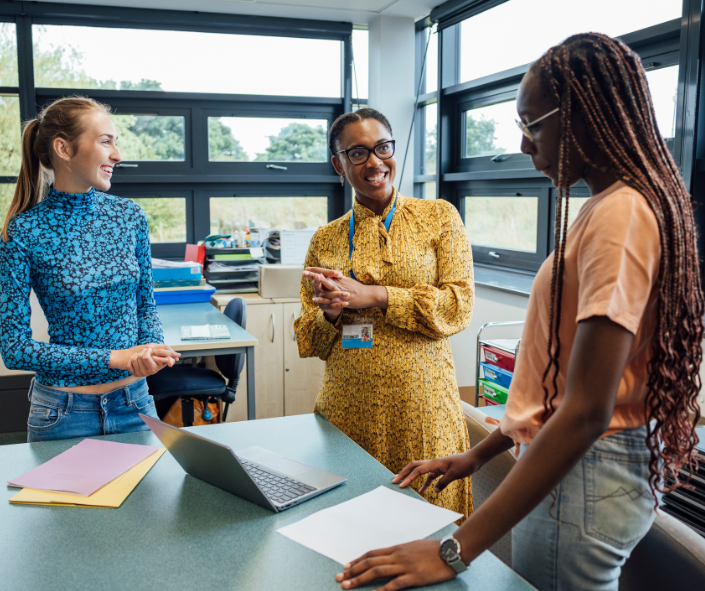Untitled design (82) Speech-language pathologists collaborating in the work room about using the SLK Curriculum to boost therapy outcomes